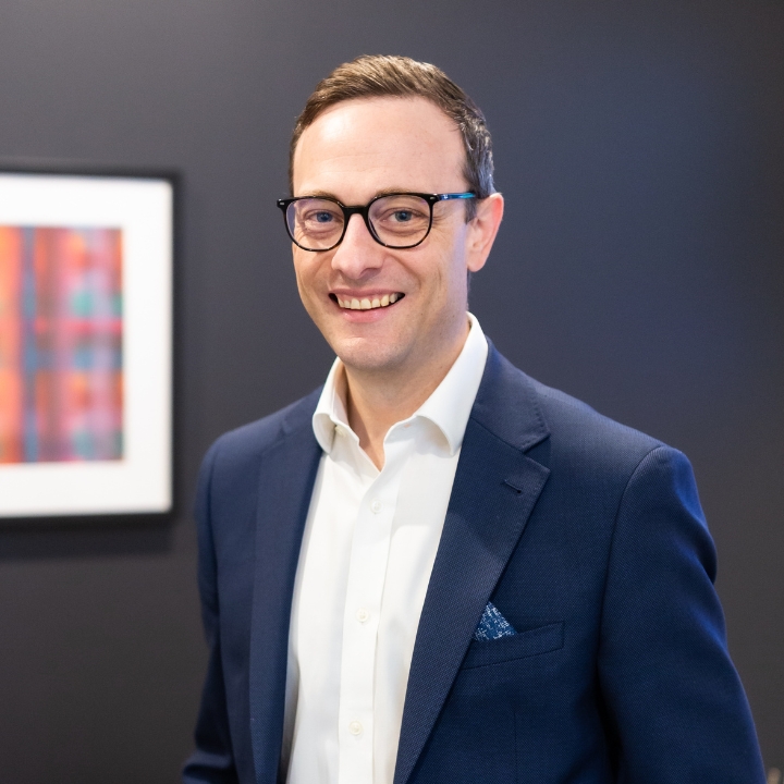 Josh Almond Mortgage Choice Broker in his office with black wall background